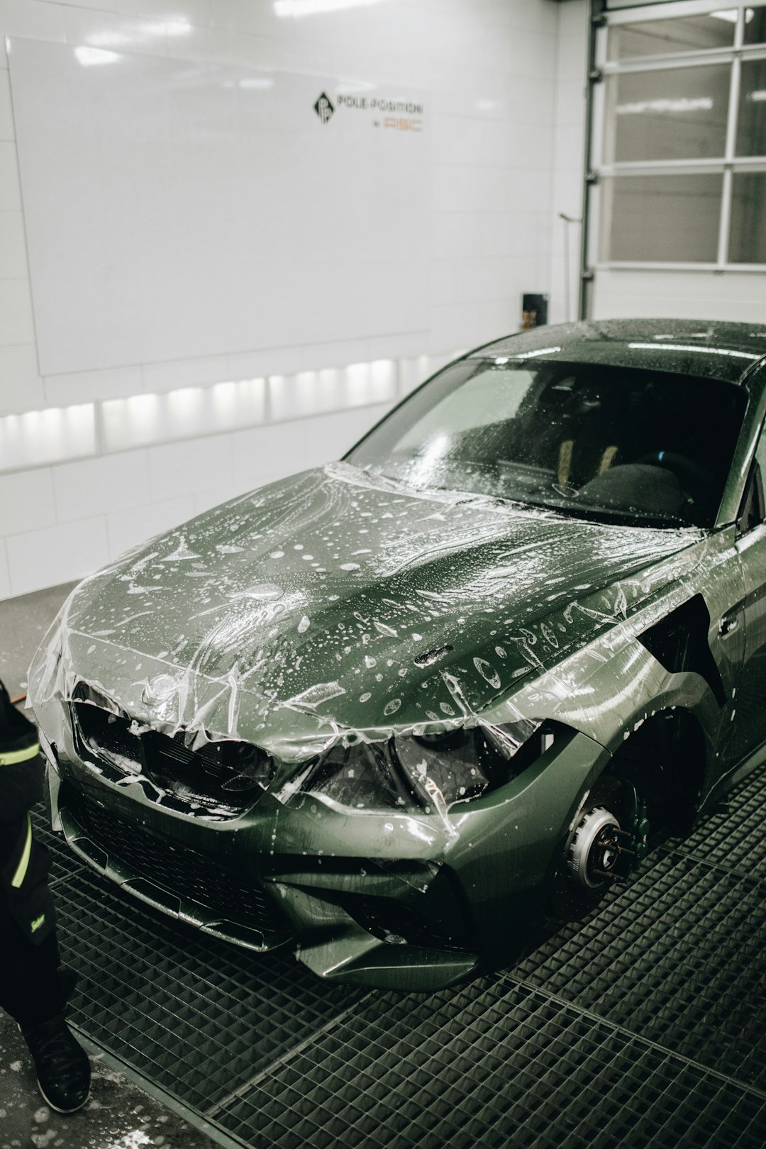 green-porsche-911-parked-in-garage-ndlie54btmg